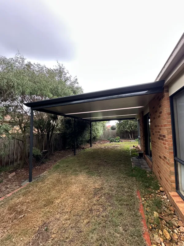 Wide view of Cooldek patio coverage over the lawn