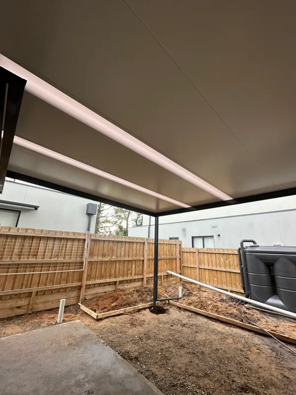 Thunder patio frame and Rooflite panels beside a modern townhouse