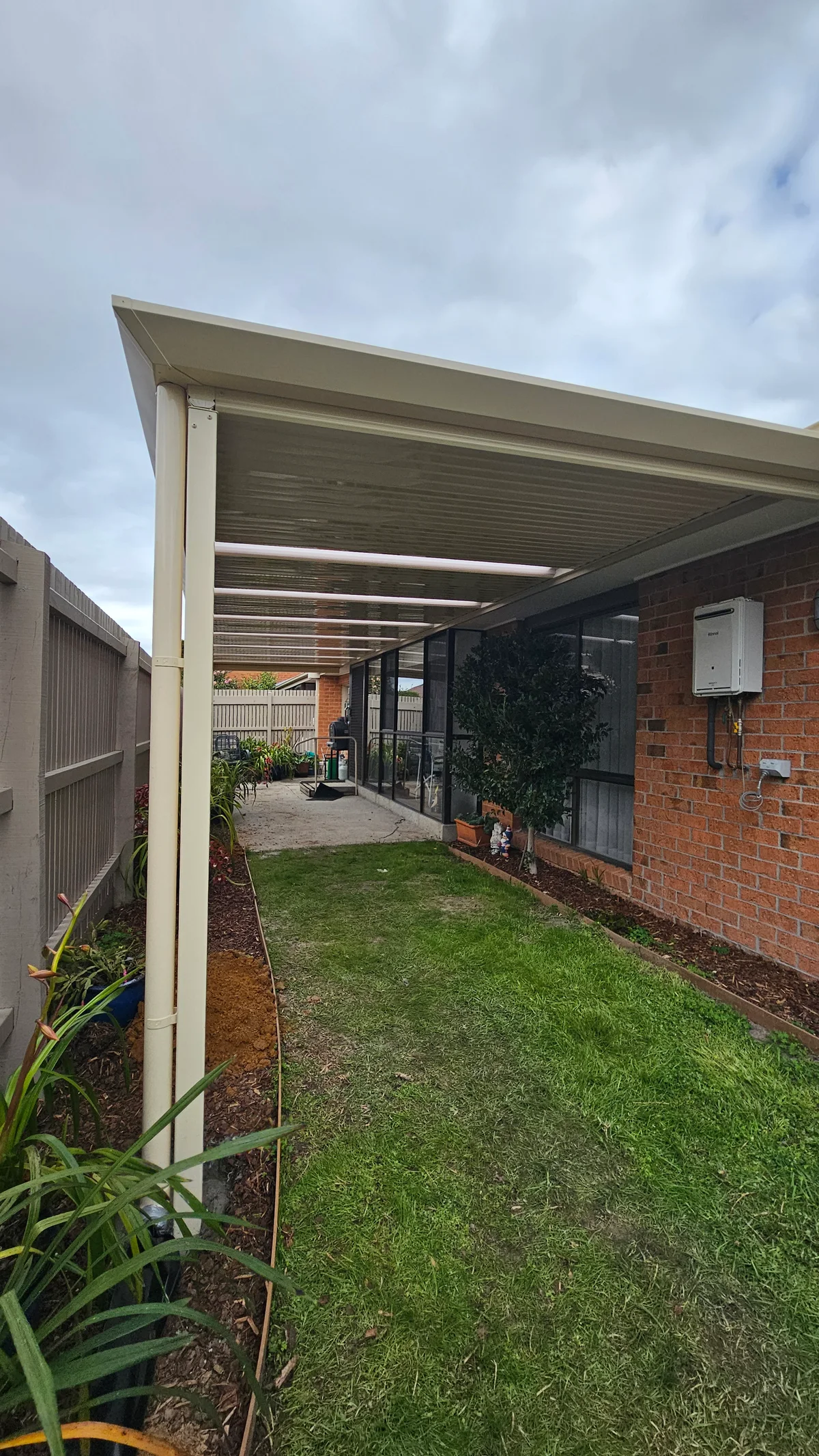Cream Stratco Outback flat patio along a Wantirna South home