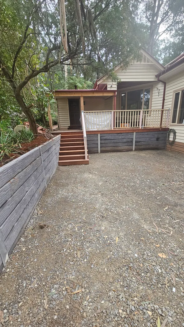 Rebuilt timber stairs connecting a raised deck to the garden